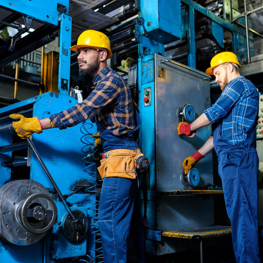 Twee mannen werken aan industriele machine